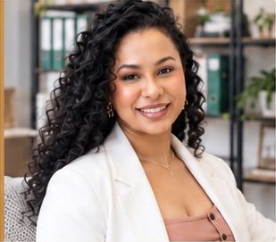 Dra. Erica Freitas wearing a white blazer in a professional setting